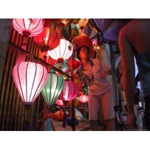 Lantern Vendor Displays Her Silk Lanterns to a Tourist During the 