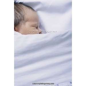  View of a premature baby asleep in a cot Framed Prints 