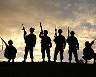 Band of Brothers , US Marines in Iraq silhouetted against a 
