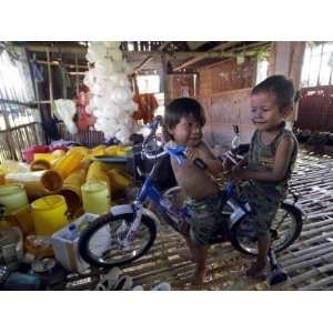  Children Play with a Bicycle Inside a Chicken Shed at 