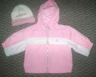   chest and a matching pink & white hat with heart design in center